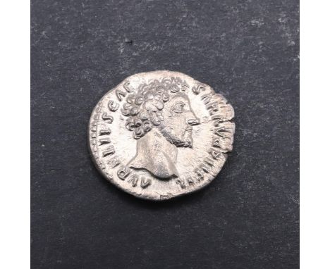 A silver Denarius, obverse with bare head r. Reverse standing figure of Genius holding a patera and standard with an altar to