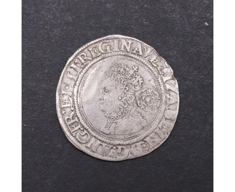 An Elizabeth I Sixpence, crowned small bust l. with rose behind. Reverse flat topped shield with date 1561 above, mint mark P