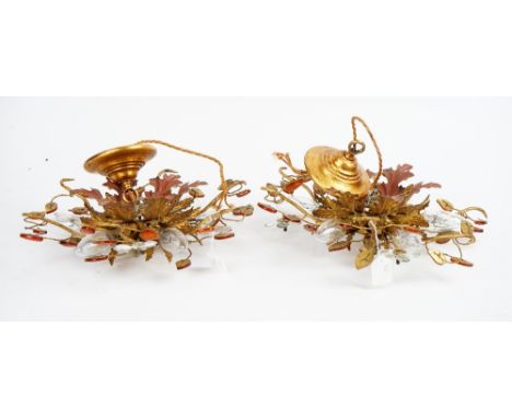 A pair of gilt metal light fittings of a leafy floral design, 38cm wide x 15cm high.