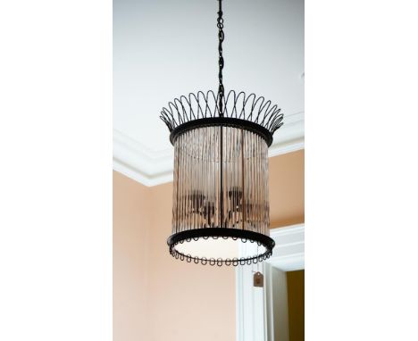 A pair of cylindrical black metal and tubular glass pendant light fittings, each of four lights, 50cm high.44cm diameter x 59