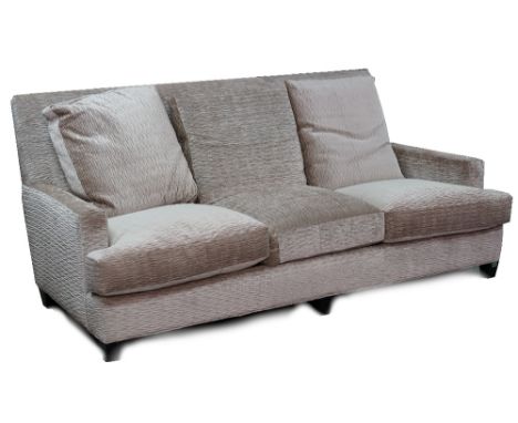 A contemporary three seat sofa, upholstered in a beige scrunched velvet with loose back seat cushions, on ebonised legs, 207c