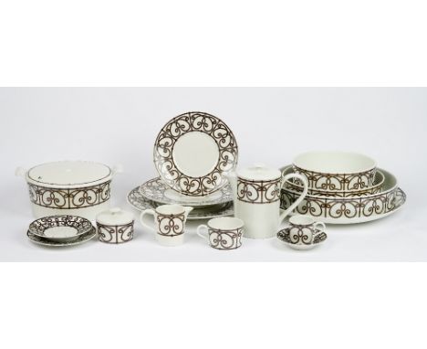 A Limoges J L Coquet tea and dinner service, essentially for eight persons, with various serving dishes and four additional c