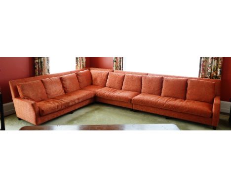 A contemporary sectional sofa, upholstered in orange and brown leopard chenille fabric with loose back and seat cushions, on 