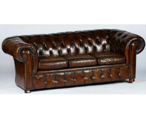 A Victorian style Chesterfield settee, button-down upholstered in brown leather, with loose seat cushions, 217cm wide x 74cm 