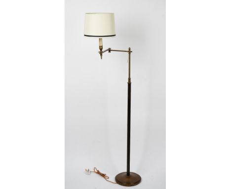 A brass floor standing adjustable lamp, 122cm high. Condition Report There are some old marks and scratches to the base and s