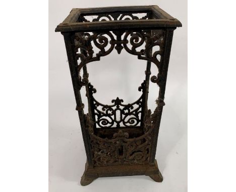 A late 19th/early 20th century cast iron stick/umbrella stand, of tall rectangular form, with decorative cut out sides, on st