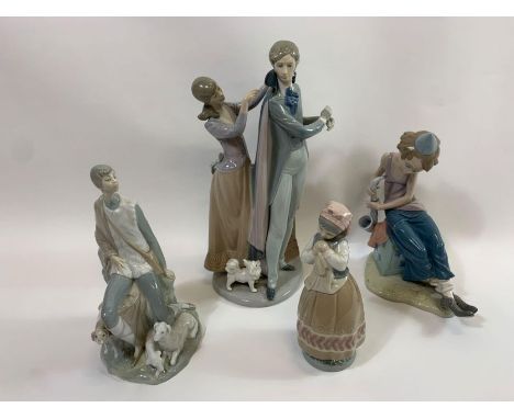 A Lladro porcelain figure of a woman assisting her husband with his cape; a Lladro figure of a clown playing the saxophone; a