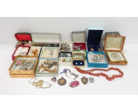A collection of costume jewellery, mainly brooches, with a row of branch coral and a travelling alarm clock                  