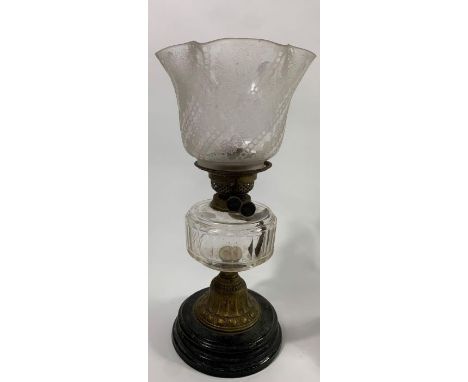 An early 20th century brass oil lamp, black painted stepped base, embossed and twisted stem, moulded clear glass reservoir, g