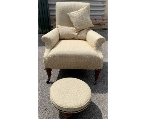 A Victorian open armchair, on four block and turned feet with casters, upholstered in a light green and yellow patterned fabr