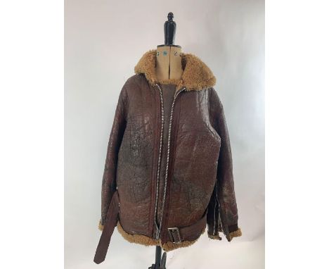 A brown leather belted flying jacket, with light brown faux fur lining, possibly WWII period