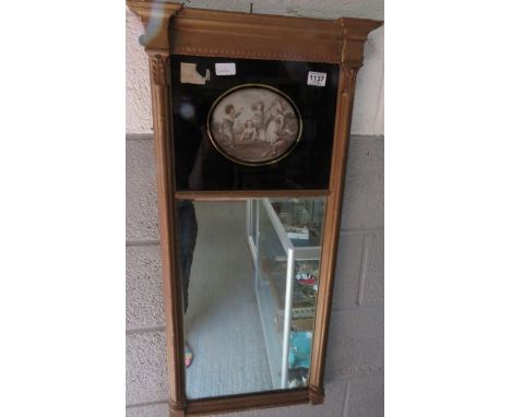 A 19th century gilt framed pier mirror, with an oval panel of children playing, 93cm high, 46cm long 
