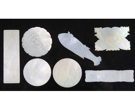 A collection of 19th century Chinese mother of pearl gaming counters/tokens, each with engraved decoration, in varying shapes