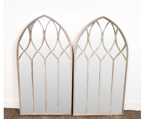 ARCHITECTURAL GARDEN MIRRORS, a pair, with arched metal frames, 125cm H x 65cm W. (2) 