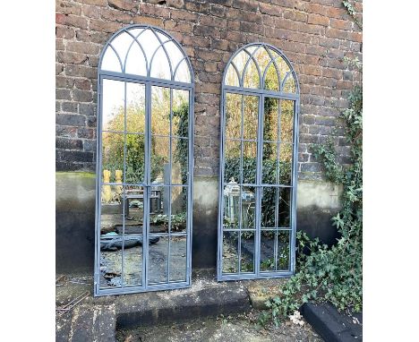ARCHITECTURAL GARDEN MIRRORS, a pair, gated design, arched metal frames, 180cm H x 75cm W. (2) 