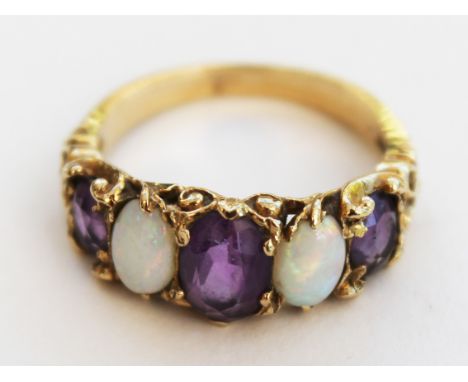 A 9ct gold opal and amethyst ring. Gross wt.3.4g. Size M