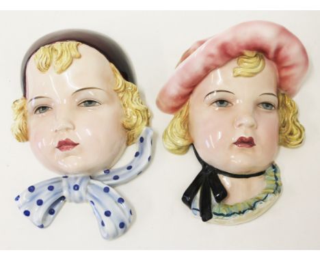 Two Goldscheider pottery wall masks. L24cm. Condition - girl with pink hat has been broken and repaired right across the neck