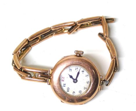 A 9ct gold cased wristwatch, the white enamel dial with Arabic hour markers and outer minutes track, 15 jewel movement within