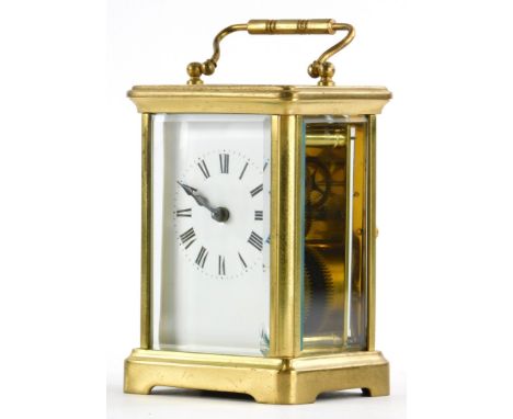 A French brass carriage clock, with a loop handle, the white enamel dial with Roman numerals, 14cm high overall.
