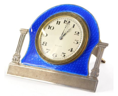 A George V silver and blue enamelled clock, by Alexander Clark and Co. ltd, with eight day movement, the dial flanked by clas