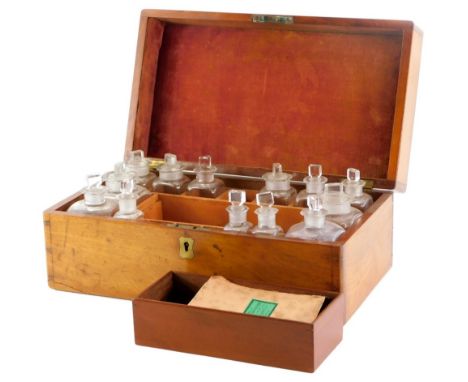 A 19thC mahogany medicine box, the rectangular hinged lid enclosing a series of bottles and stoppers, brass scales with weigh