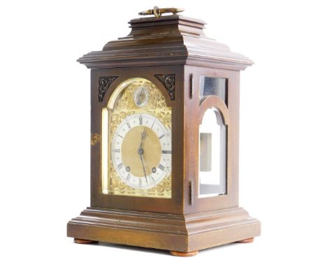 A 20thC mahogany mantel clock, the arched dial with applied rococo scroll spandrels, a regulator dial and a silvered chapter 