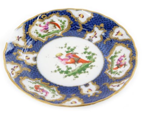 A Samson French porcelain plate, decorated with Asiatic pheasants, within rococo gilt raised cartouches, on a blue scale grou