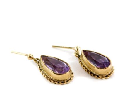 A pair of 9ct gold amethyst drop earrings, the teardrop cut amethyst in a raised setting with rope twist border, lacking back