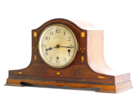 An early 20thC mahogany cased mantel clock, with a silvered dial, the case inlaid in mother of pearl and marquetry, in Art No