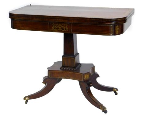 A Regency rosewood and brass inlaid card table, the D shaped top with a crossbanded border, decorated with scrolls, leaves, e