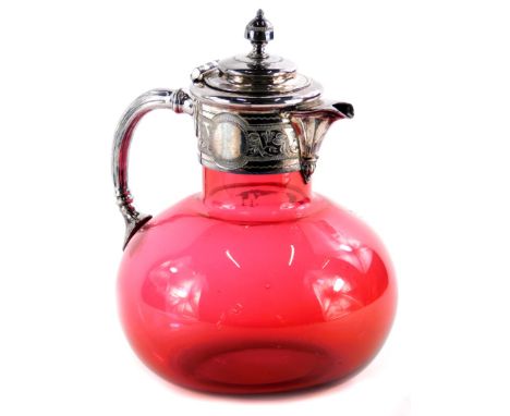 A Victorian cranberry tinted glass claret jug, with engraved silver plated mounts, 20cm high.