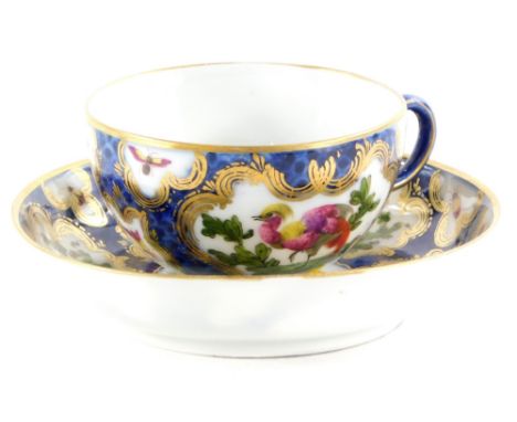 A Samson French porcelain cup and saucer, decorated in Worcester style with Asiatic pheasants and insects, within gilt cartou