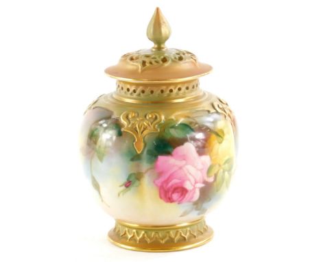 A Royal Worcester porcelain pot pourri jar and cover,  the pierced lid with a shaped finial, the base painted with roses, on 