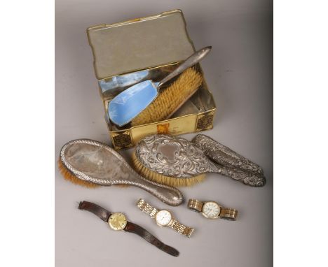 A tin containing mixed silver back brushes etc and a quantity of watches Josmar manual wristwatch.  