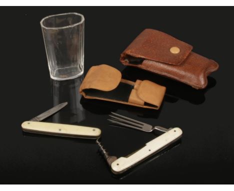 An assembled early 20th century gentleman's campaign dining set in leather case. With cut glass beaker and folding knife and 