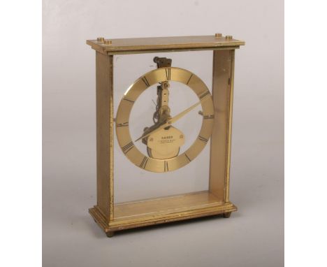A Kaiser brass cased 7 jewel 8 day carriage clock. With perspex front and back and floating skeleton mechanism, 14cm.  Runnin