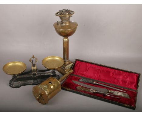 A cast set of W &amp; T Avery kitchen scales, brass Corinthian column oil lamp, cased carving set and a clockwork spit jack. 
