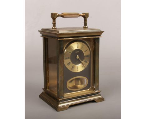 An Acctim brass cased 8 day carriage clock. With bob pendulum and striking on a bell, 18cm.  Running. Case in good order.