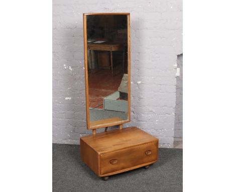 An Ercol light elm cheval mirror.  
