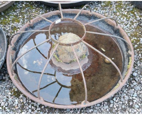 A vintage cast iron Mexican hat shaped trough with cage.  