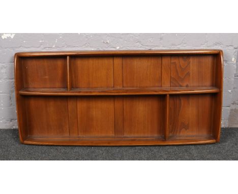 An Ercol light elm wall shelving rack.  