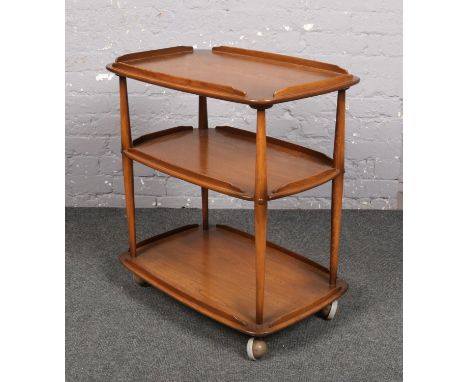 An Ercol light elm three tier tea trolley.  
