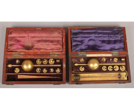 Two mahogany cased Sikes's hydrometers. Makers Buss and Louis Casartelli. Along with Sikes tables a book of hydrometer tables