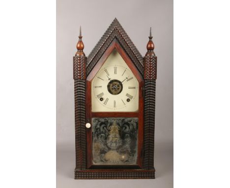 A 19th century American carved rosewood cathedral clock. With painted dial, incorporating an alarm function and stiking on a 