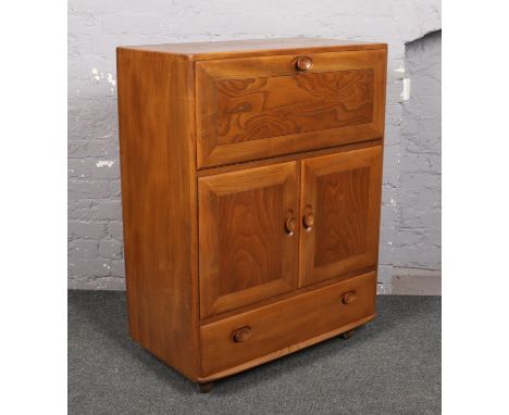 An Ercol light elm drinks cabinet. (Height 109cm Width 83cm Depth 44cm)  