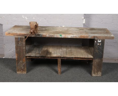 A vintage wooden work bench with vice.  