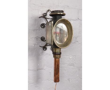 A Victorian carriage lantern, with wall mounting bracket.  Crack to both panes of glass.