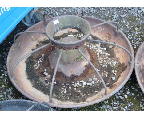 A vintage cast iron Mexican hat shaped trough with cage.  