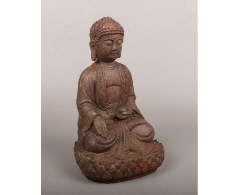 A late 19th century Chinese iron statue formed as a seated Buddha raised on a lotus throne, 24cm.  