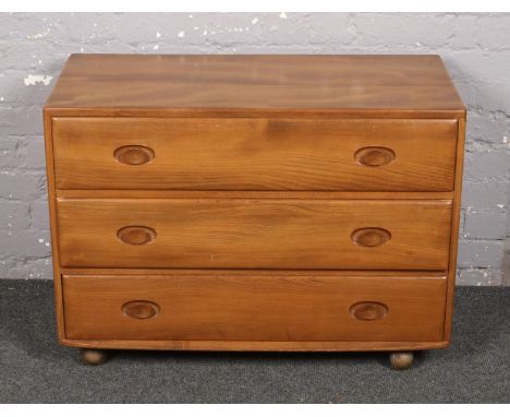 An Ercol light elm chest of three drawers. (Height 66cm Width 92cm Depth 45cm).  